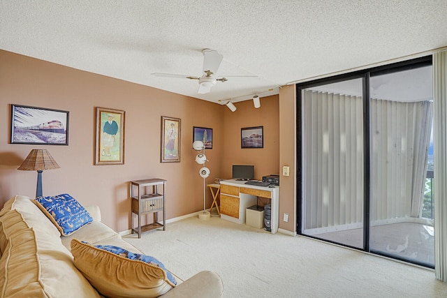 carpeted living room featuring rail lighting, ceiling fan, and a textured ceiling