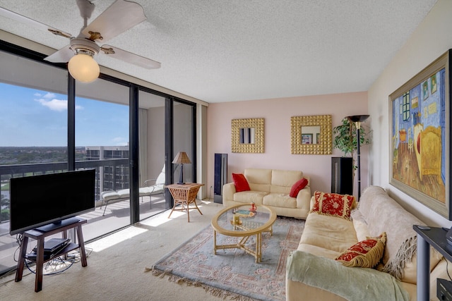 carpeted living room with ceiling fan, floor to ceiling windows, and a textured ceiling