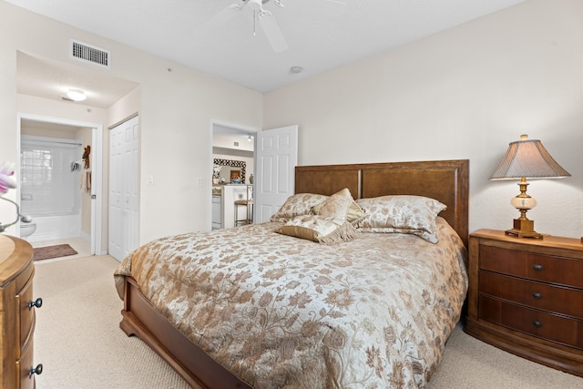 bedroom featuring ensuite bath, ceiling fan, a closet, and light colored carpet