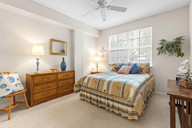 carpeted bedroom featuring a textured ceiling and ceiling fan