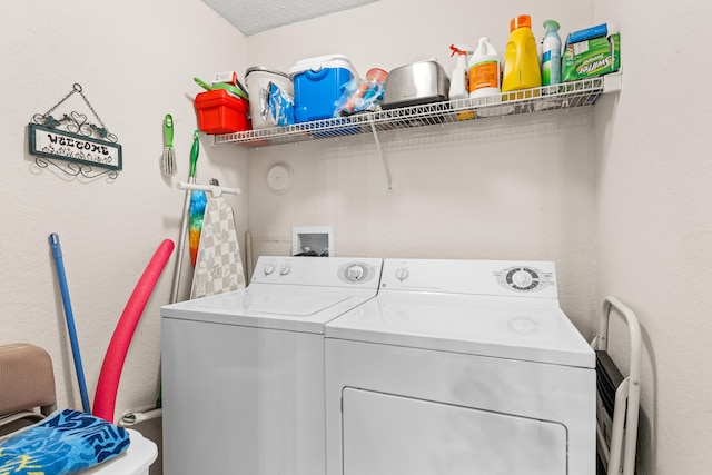 laundry area featuring washer and dryer and a textured ceiling