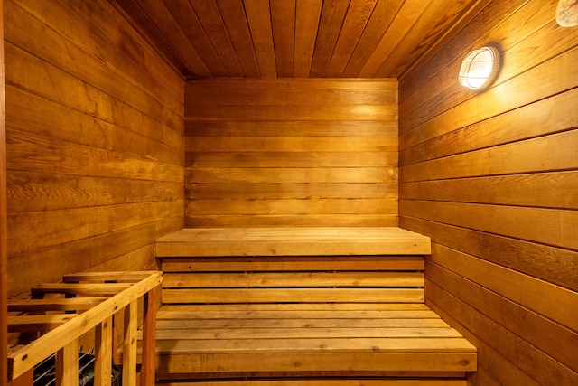 view of sauna with wood walls and wood ceiling