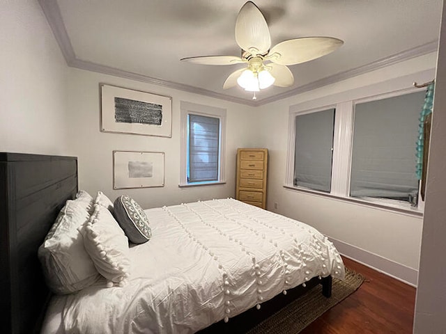 bedroom featuring dark hardwood / wood-style floors, ceiling fan, and crown molding