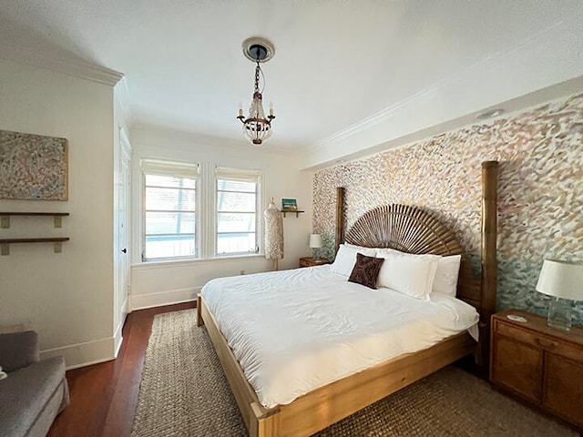 bedroom with dark hardwood / wood-style flooring, a chandelier, and ornamental molding