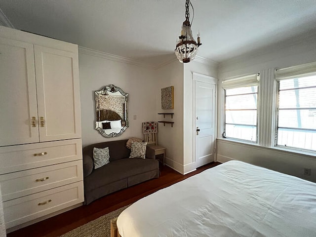 bedroom featuring crown molding and dark wood-type flooring