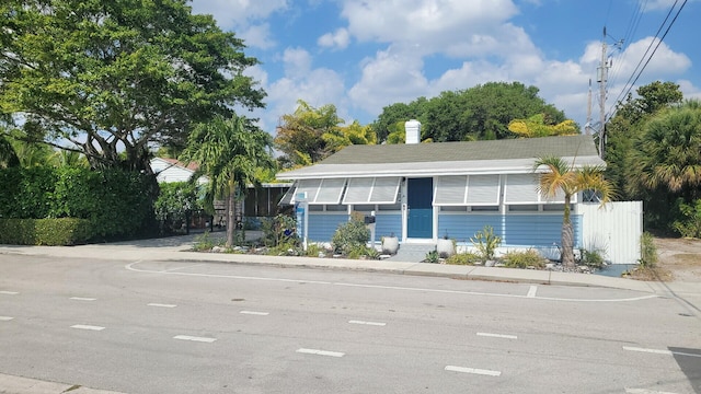 view of front of property with basketball hoop