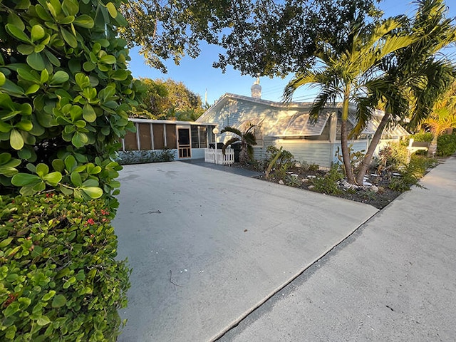 view of property exterior featuring a sunroom