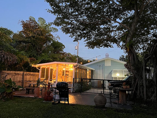 rear view of house featuring a patio area and a lawn