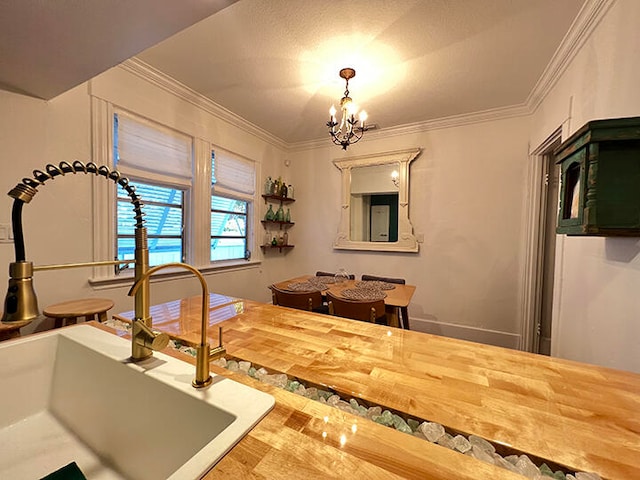 interior space featuring wood-type flooring, sink, crown molding, and a notable chandelier