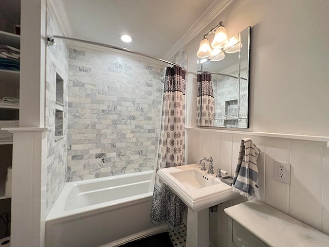 bathroom with shower / bathtub combination with curtain, ornamental molding, and sink