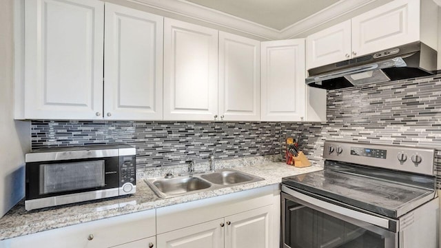 kitchen featuring backsplash, crown molding, sink, white cabinetry, and stainless steel appliances