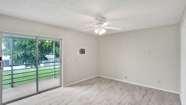 empty room featuring ceiling fan and a textured ceiling