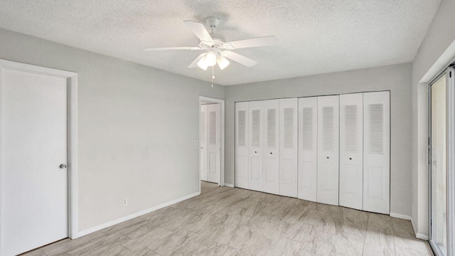 unfurnished bedroom featuring a textured ceiling and ceiling fan