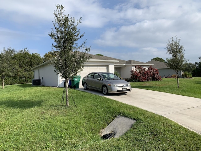 view of front of home with a front lawn, central AC unit, and a garage