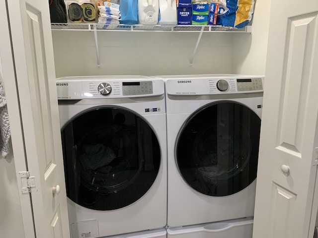 clothes washing area featuring washer and clothes dryer