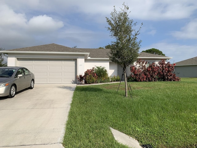 ranch-style house featuring a front yard and a garage