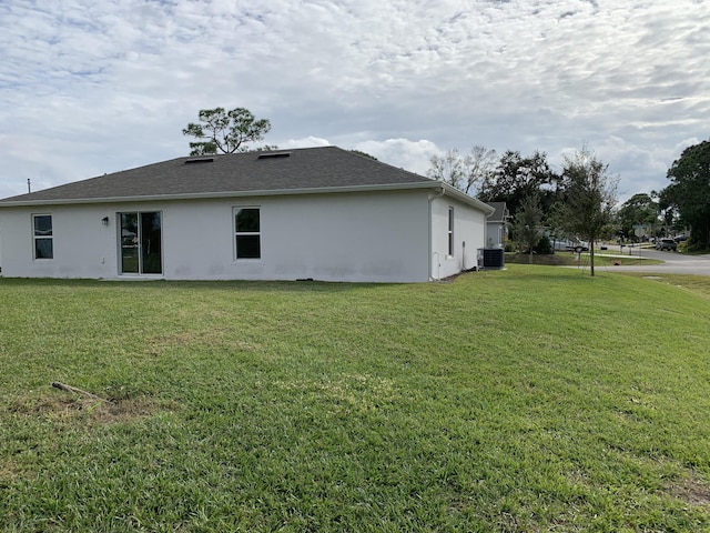 view of home's exterior featuring a yard and cooling unit