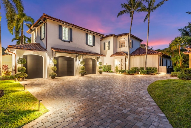 mediterranean / spanish-style house featuring a garage