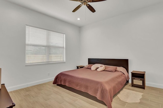 bedroom with ceiling fan and light hardwood / wood-style flooring