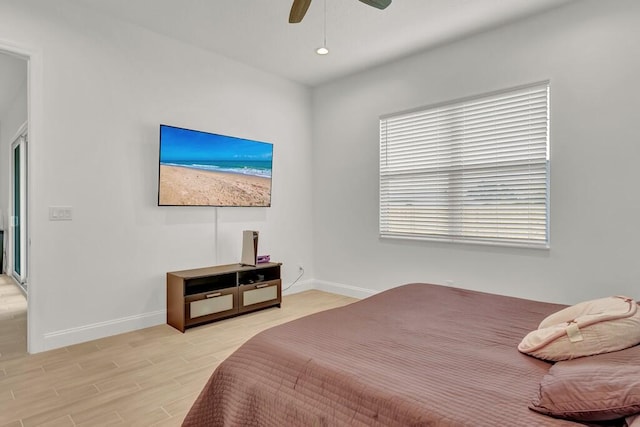 bedroom with ceiling fan and light hardwood / wood-style floors