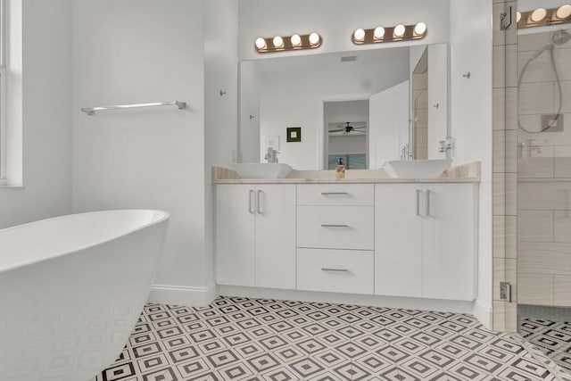 bathroom featuring ceiling fan, vanity, and independent shower and bath