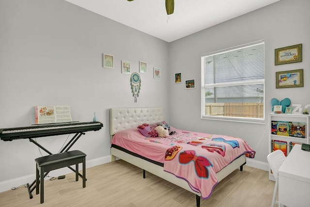 bedroom with ceiling fan and light wood-type flooring