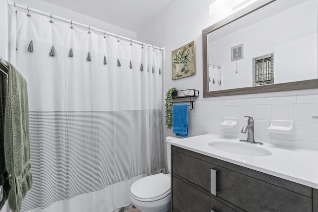 bathroom featuring decorative backsplash, vanity, toilet, and tile walls