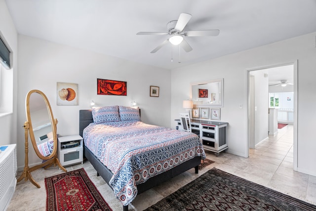 bedroom featuring light tile patterned floors and ceiling fan