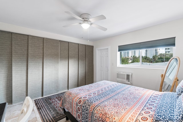 bedroom featuring a wall mounted AC and ceiling fan