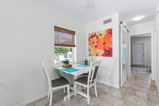 dining room featuring a barn door