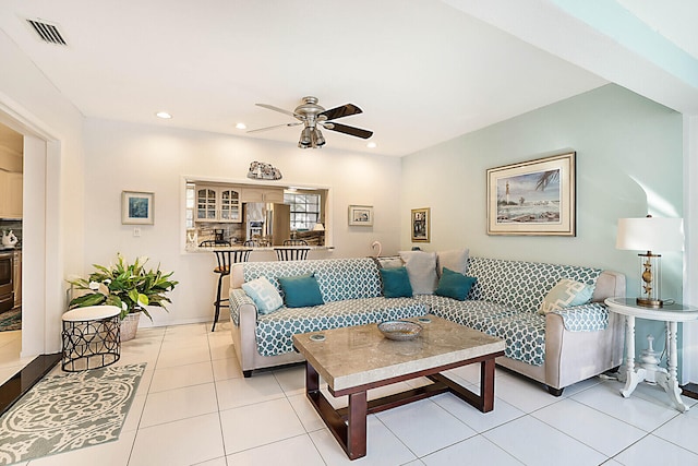 tiled living room featuring ceiling fan