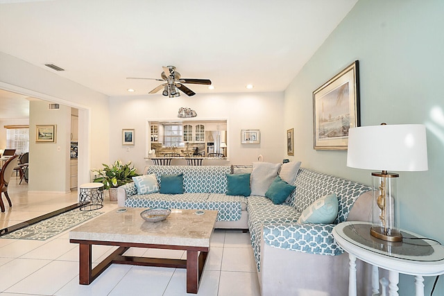 living room with light tile patterned floors and ceiling fan