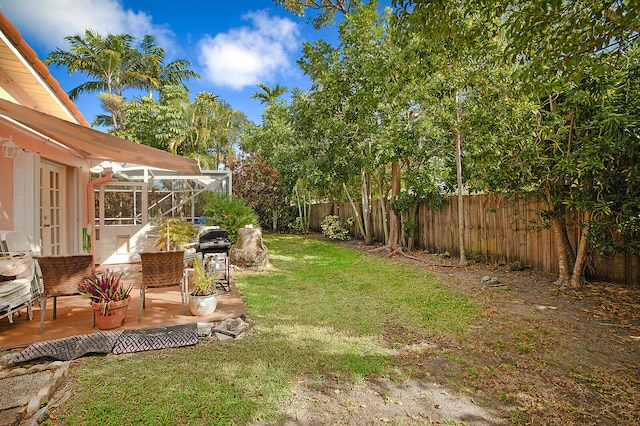 view of yard with glass enclosure