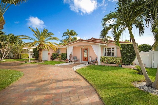 view of front facade with a garage and a front yard