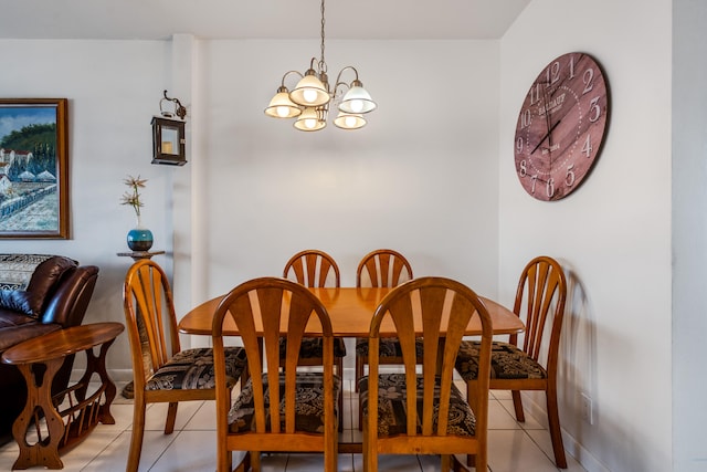 tiled dining room featuring an inviting chandelier