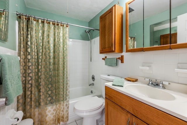 full bathroom with vanity, toilet, tile walls, and shower / tub combo