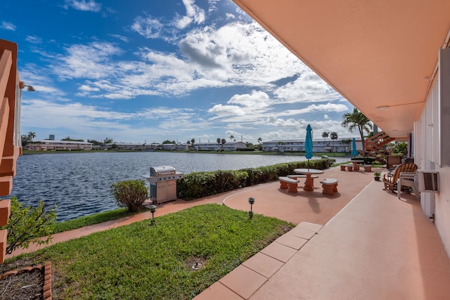 exterior space featuring a patio and a water view