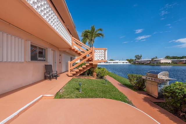 view of yard with a patio area and a water view