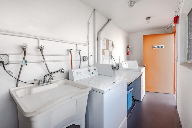 laundry room with separate washer and dryer and sink