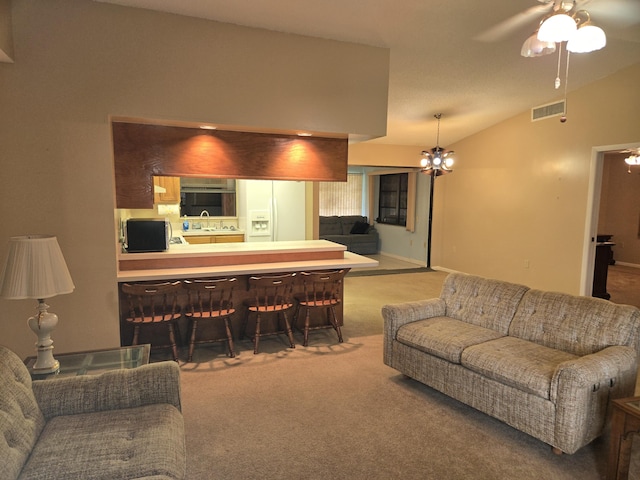 living area featuring lofted ceiling, ceiling fan with notable chandelier, carpet, and visible vents