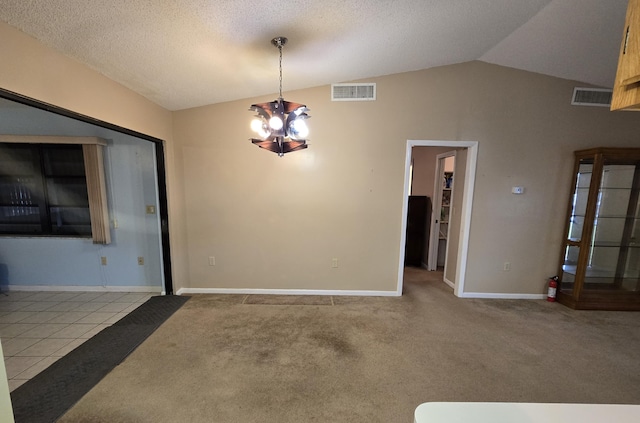 interior space with a textured ceiling, a chandelier, light colored carpet, and lofted ceiling