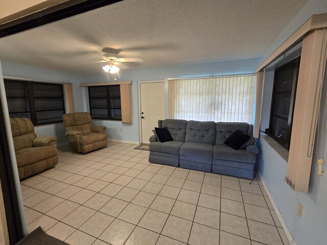 interior space with tile patterned flooring, a textured ceiling, and an inviting chandelier