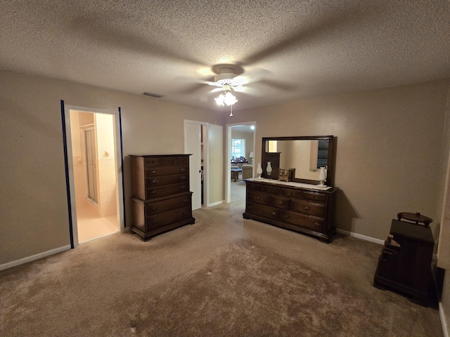 bedroom with ceiling fan, a textured ceiling, light carpet, visible vents, and baseboards