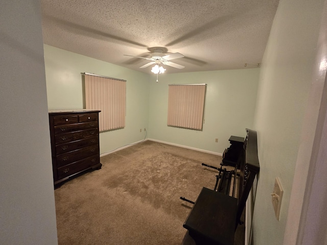 bedroom featuring a ceiling fan, carpet, a textured ceiling, and baseboards