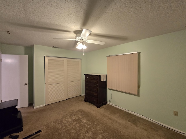 unfurnished bedroom featuring light carpet, ceiling fan, a closet, and a textured ceiling