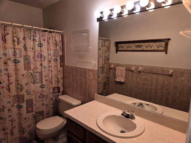 bathroom with vanity, a shower with shower curtain, tile walls, and toilet