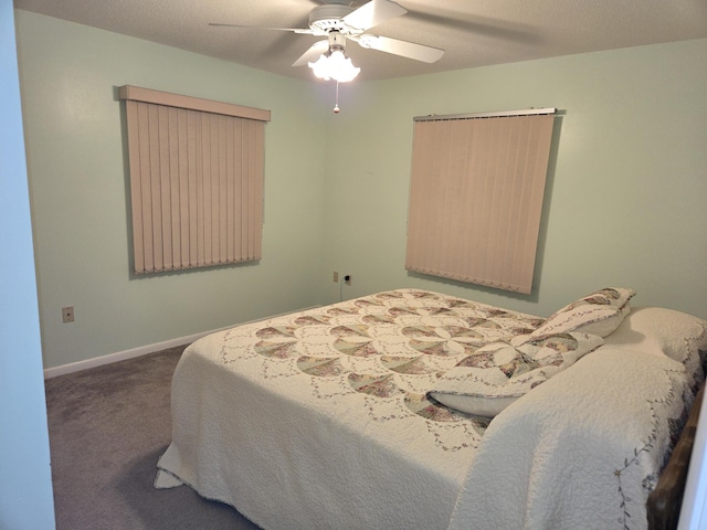 carpeted bedroom with baseboards and a ceiling fan