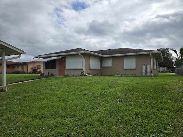 view of front of home with a front yard and stucco siding