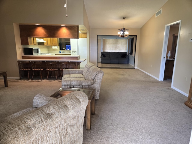 living room with baseboards, visible vents, a chandelier, and light colored carpet