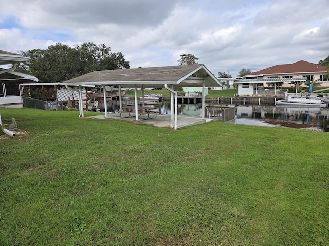 view of dock featuring a water view and a lawn